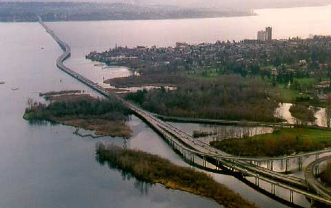aerial view of the SR 520 floating bridge in the early morning with mist on the water 