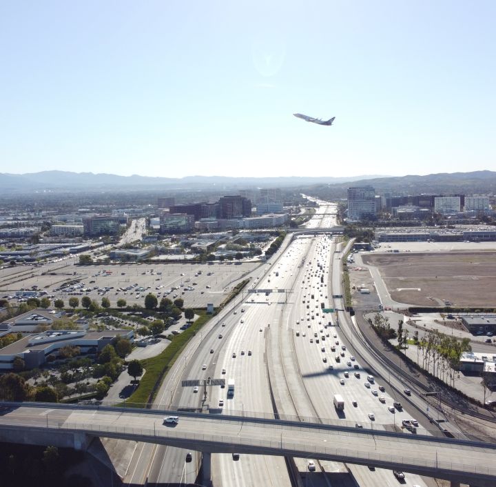 aerial of I-405 with plane flying above