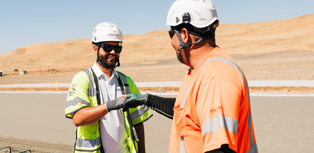 construction workers fist bumping