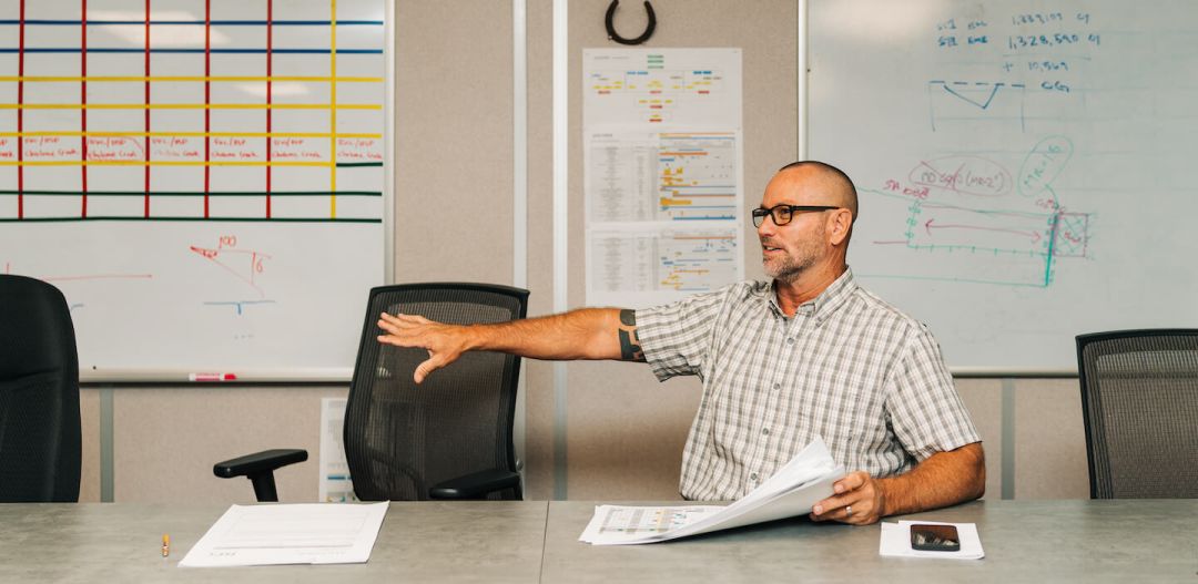 man sitting and gesturing