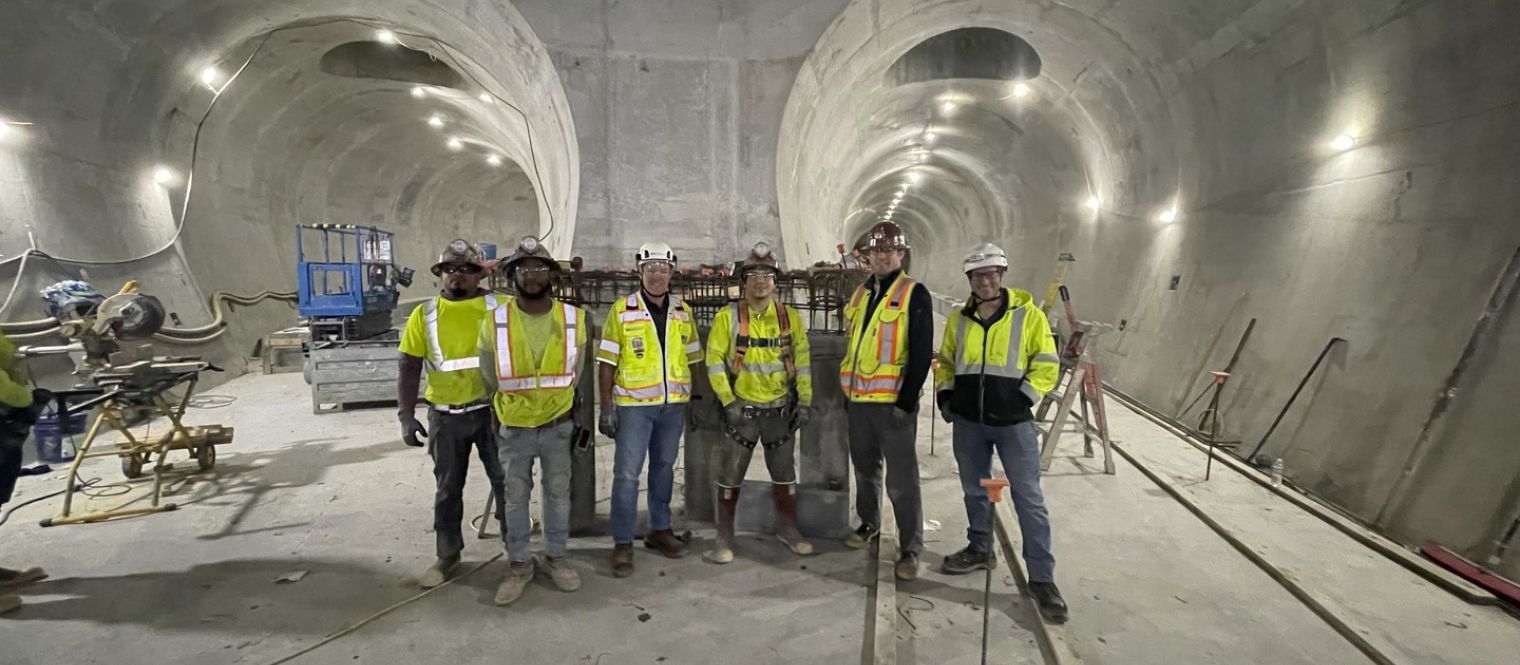 Tunnel interior at bifurcation, team group photo