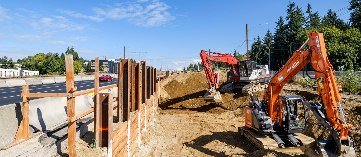 With two excavators working adjacent to the support of excavation wall.