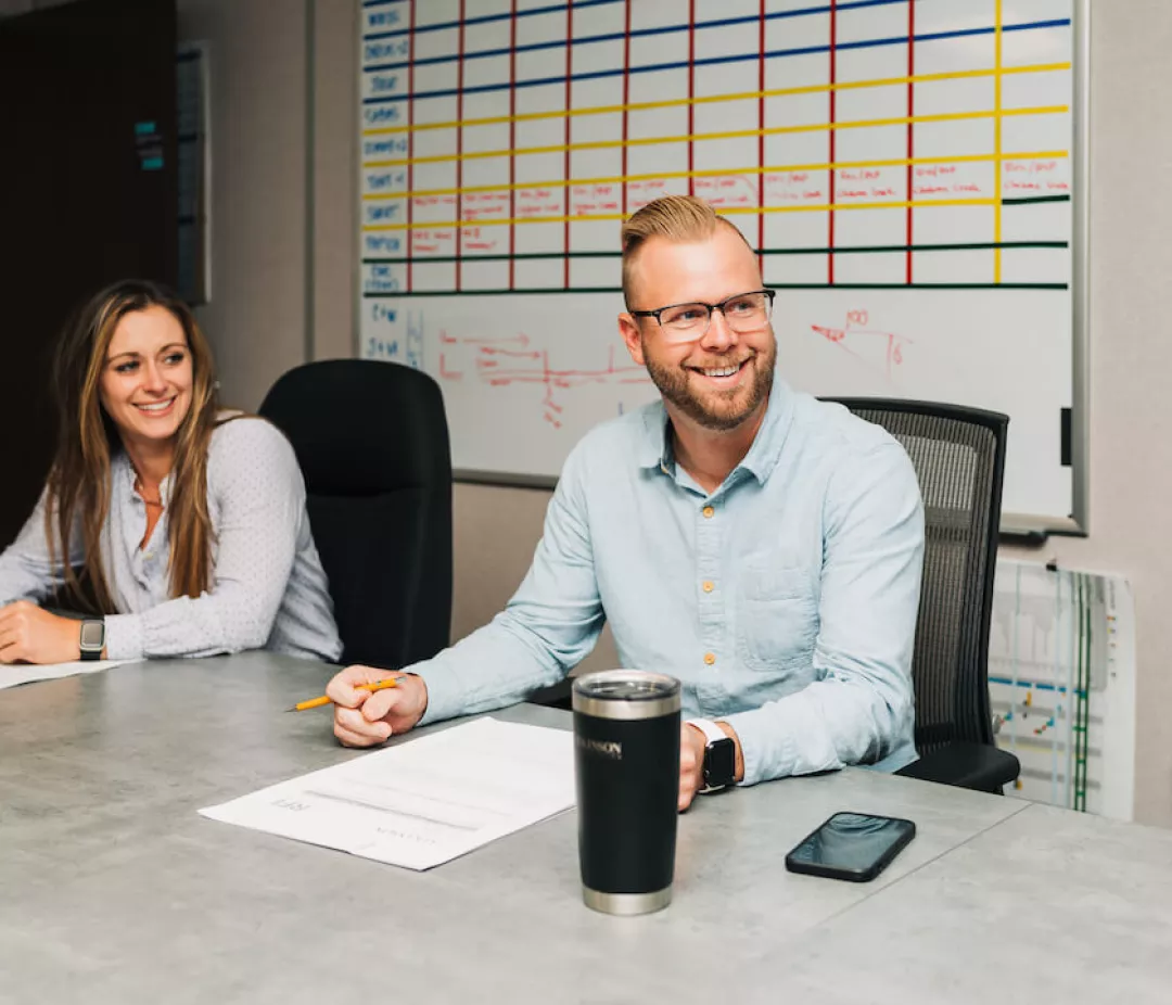 man and woman sitting at desk