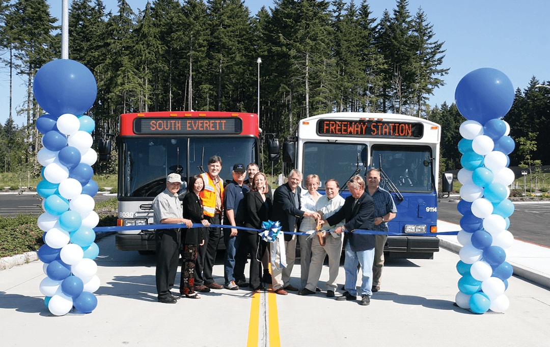 ribbon cutting ceremony for south everett station in front of buses