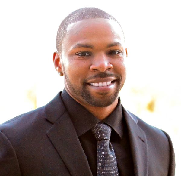 Barry Jackson headshot photo in a black suit and tie 