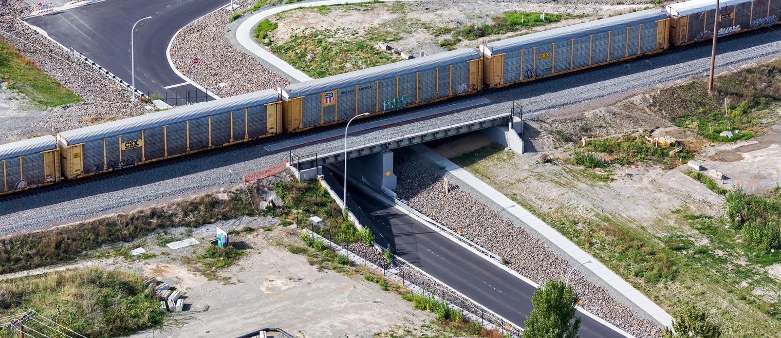 A Train crosses the Strander Boulevard Bridge