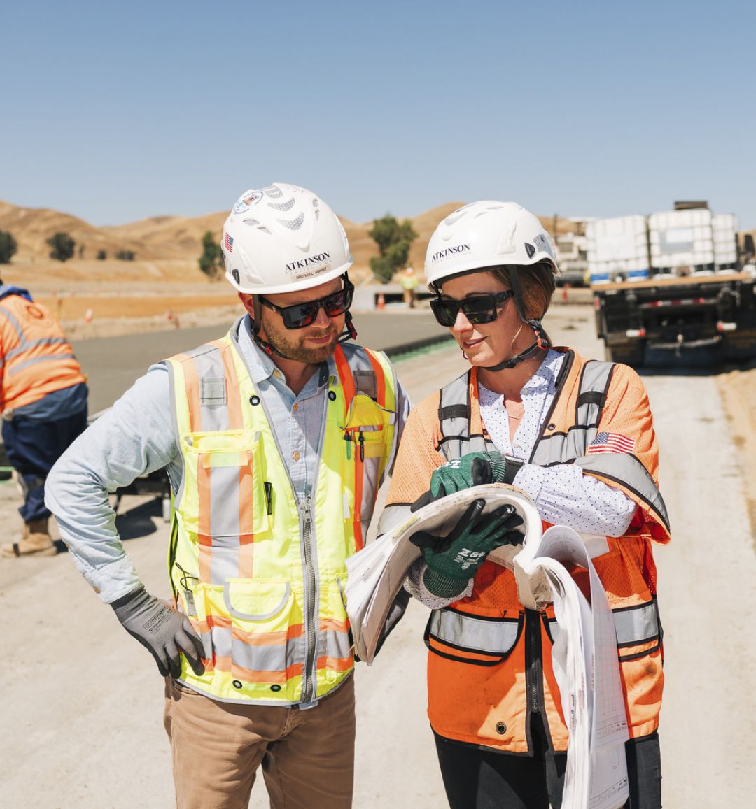 Atkinson team members discuss project plans on the jobsite